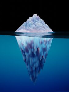 a large iceberg floating in the water